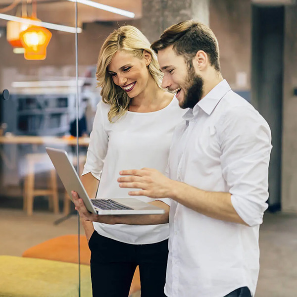 Man and woman looking at a laptop together