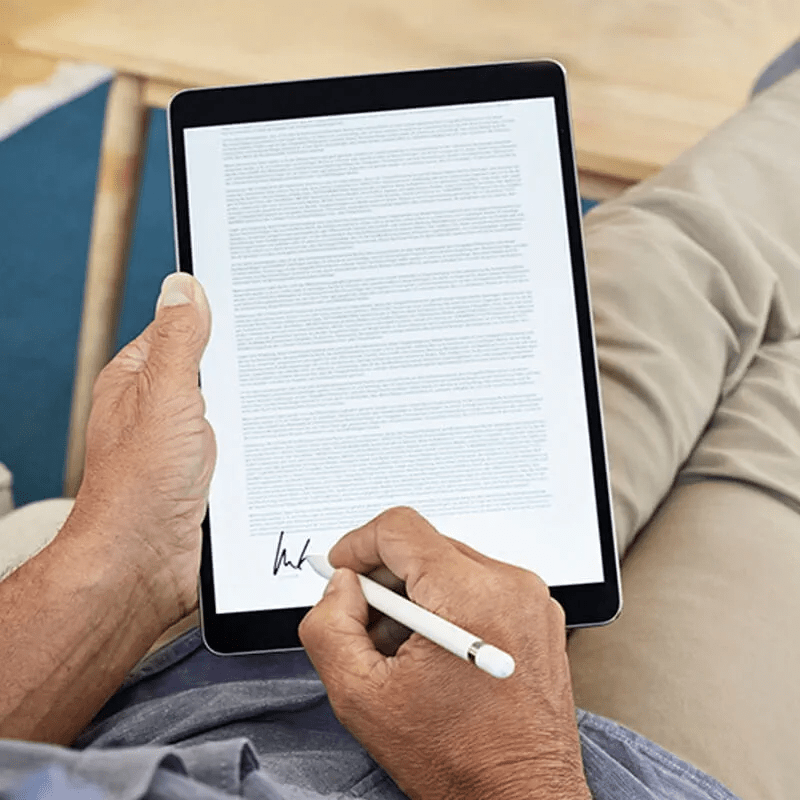 person writing on a tablet with a stylus