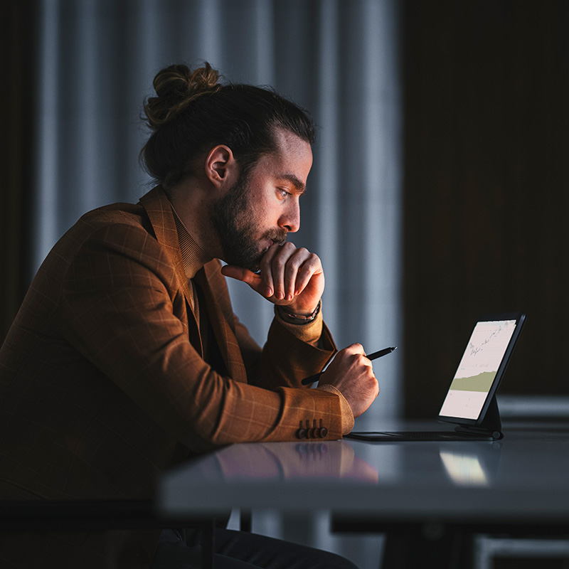 Man using a tablet in the dark