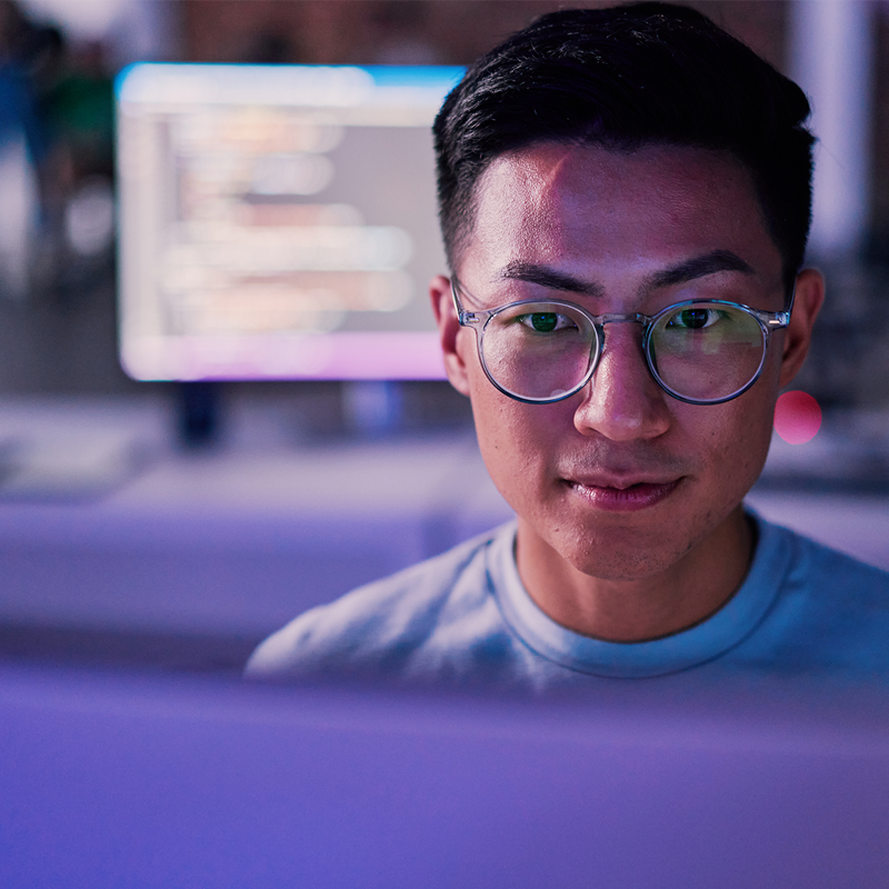 man with glasses working on a computer