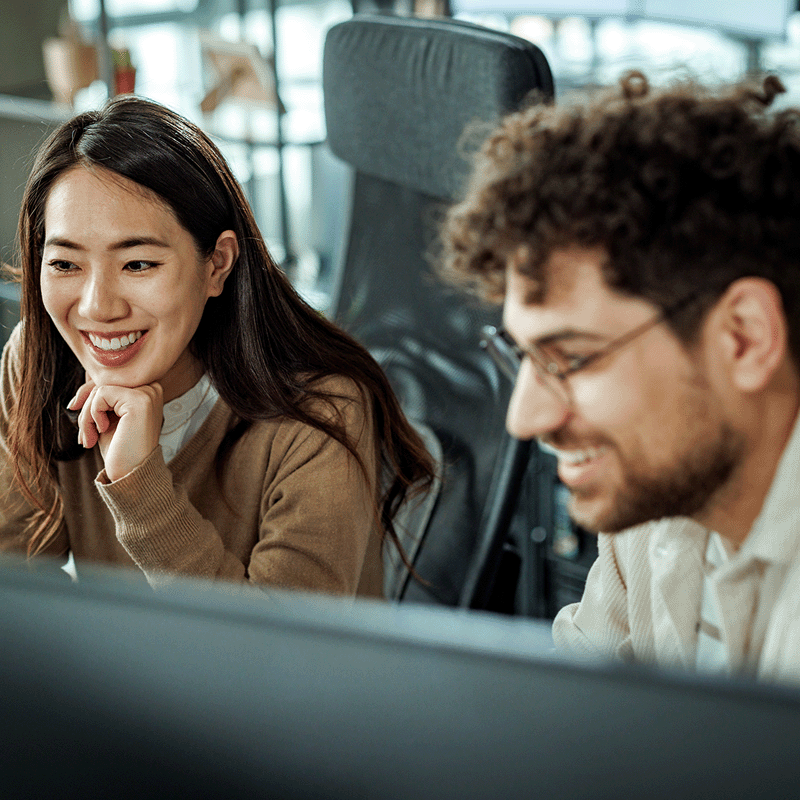 Man and woman working on computers
