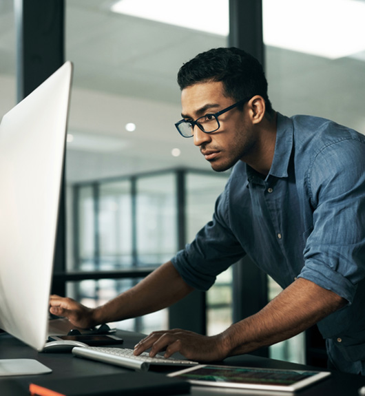 man standing at computer