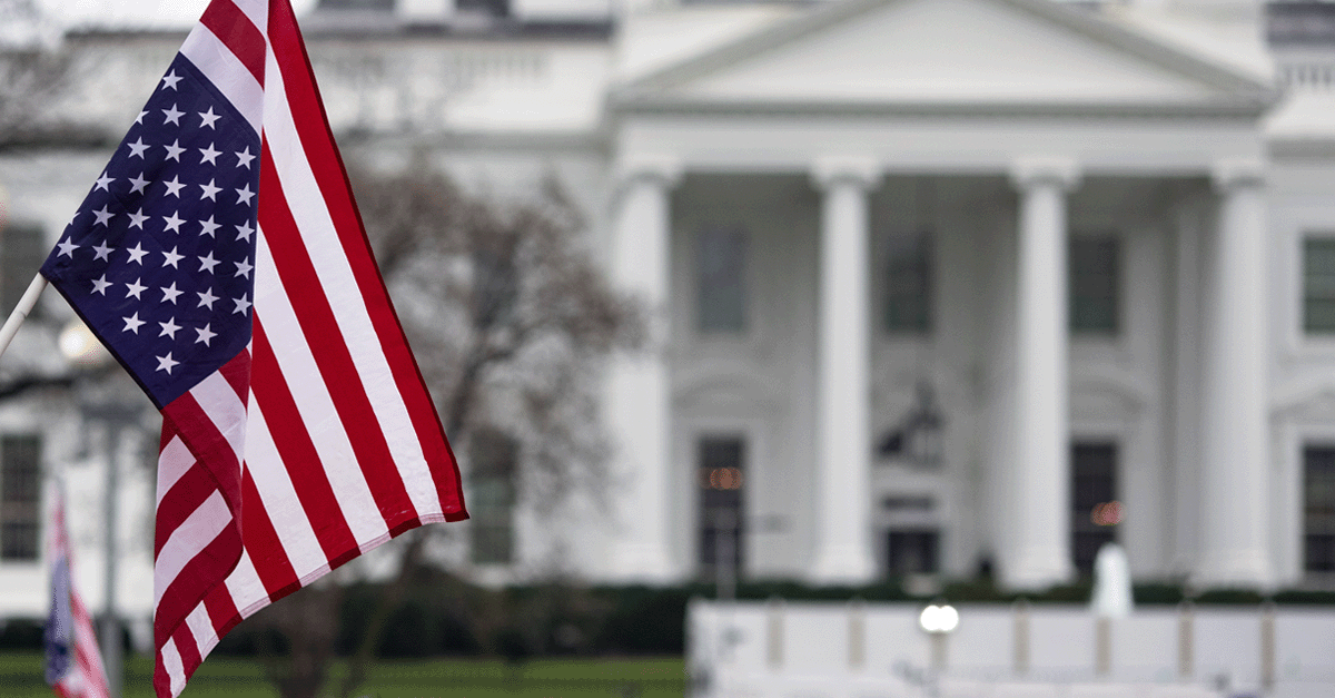 American flag in front of the white house