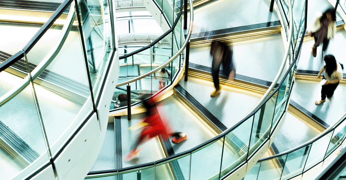 People walking down a spiral staircase
