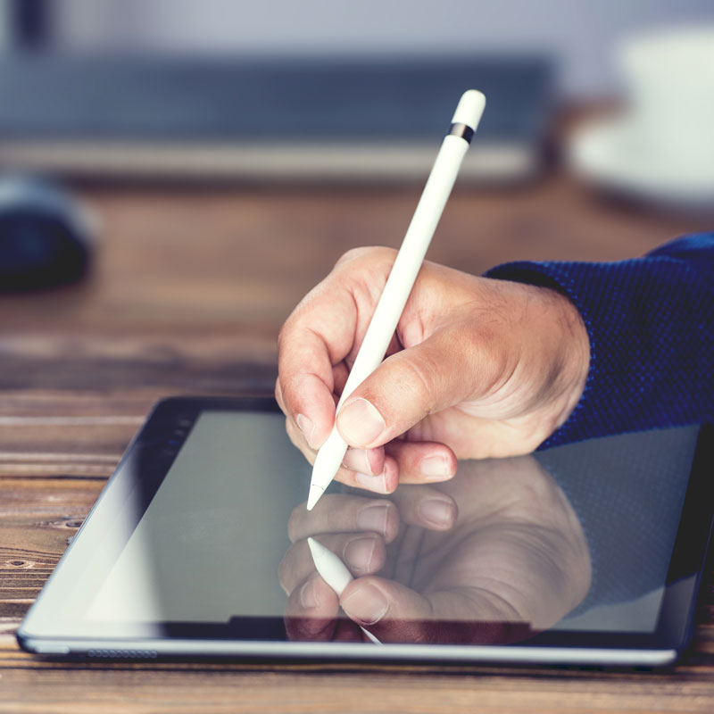 Person writing on a tablet