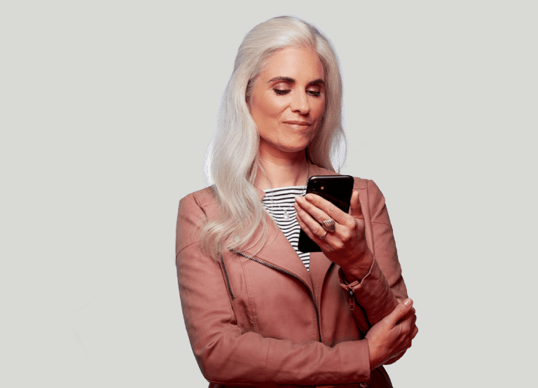 woman smirking looking at a phone