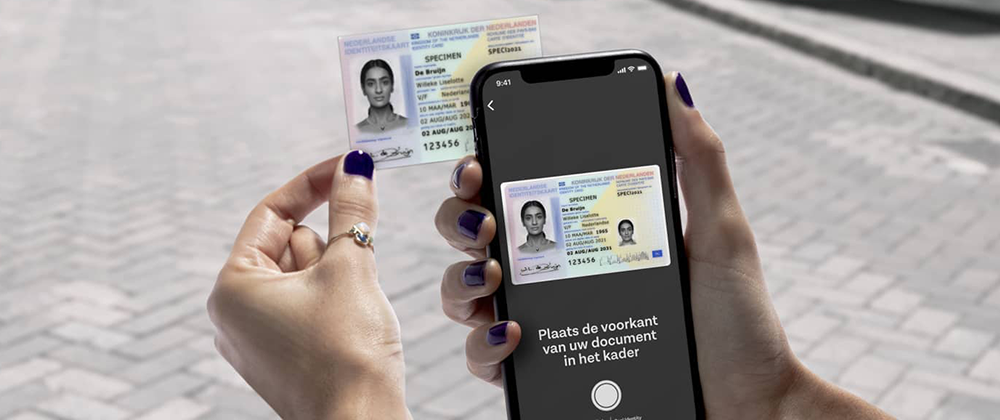 woman's hands using mobile phone to scan her id