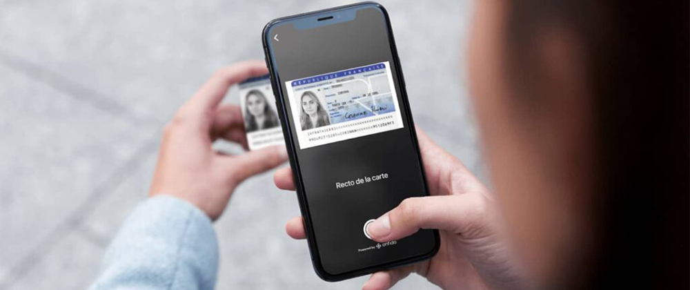 mobile phone scanning a woman's ID card