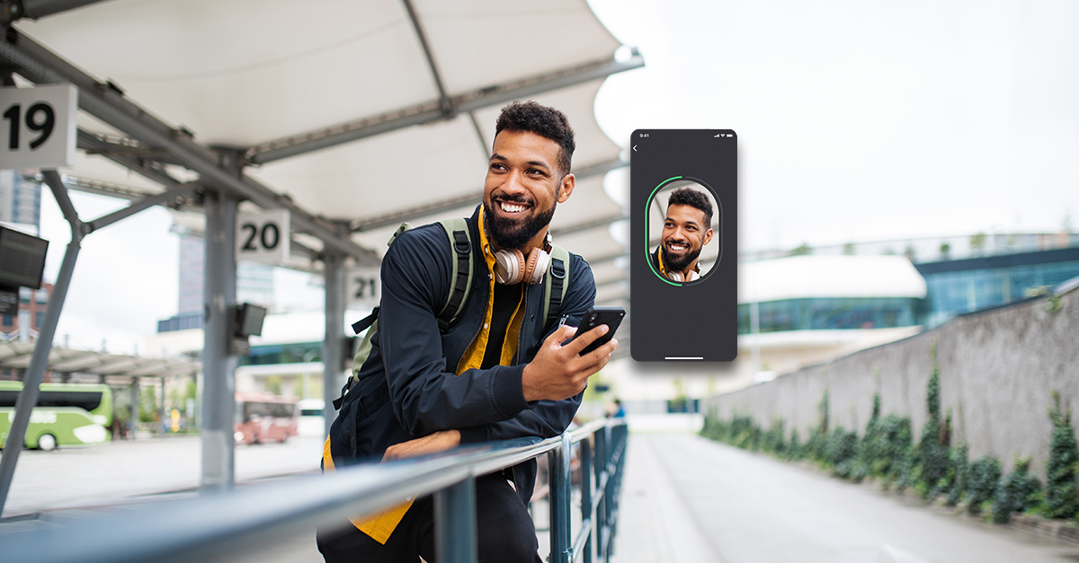man smiling at screenshot of digital identity on phone