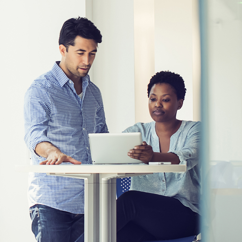 Two people looking at a laptop