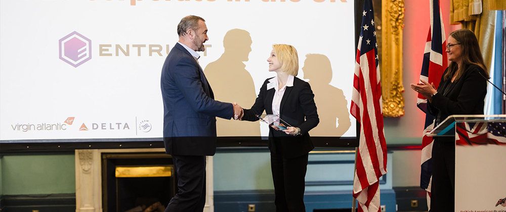 Man and woman shaking hands on stage