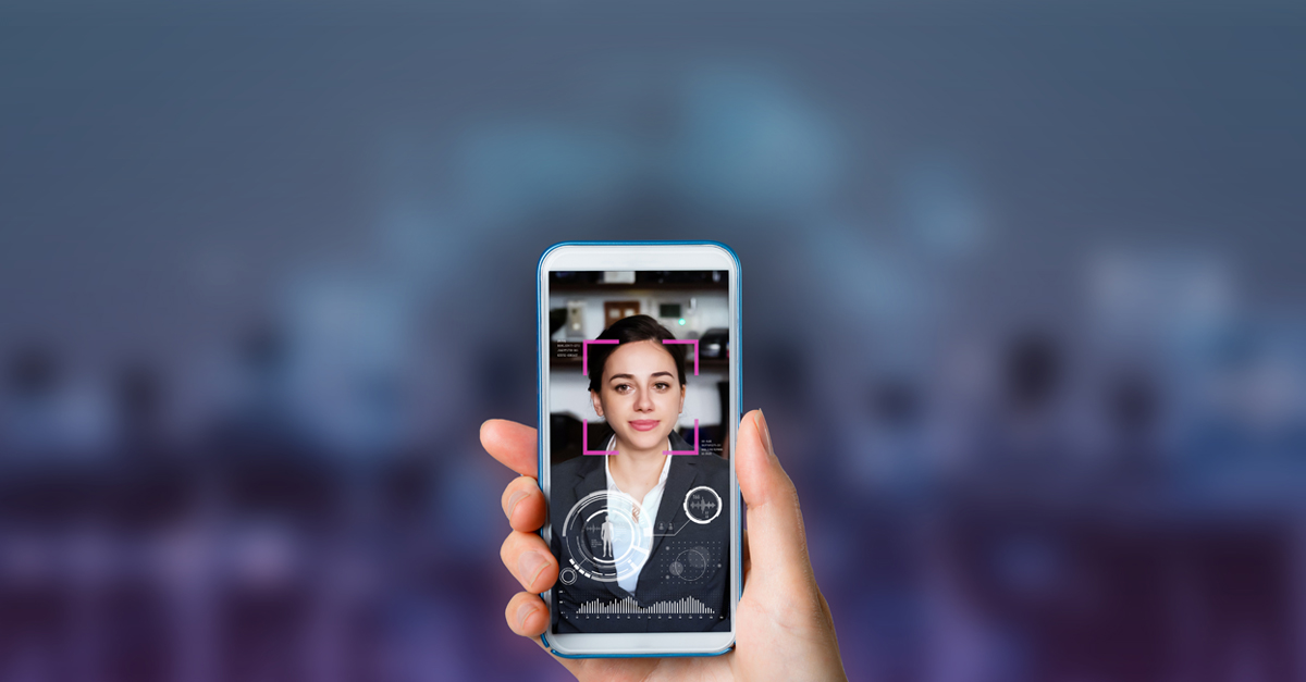 Hand holding a phone with woman on the screen