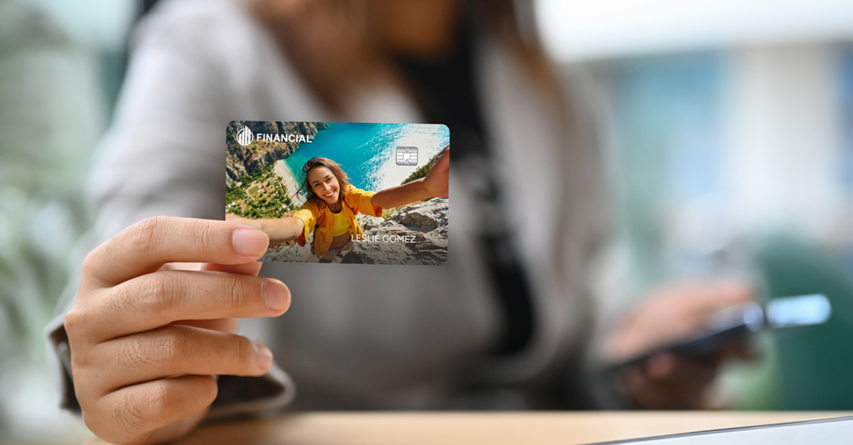 Person holding a credit card with an outdoor adventure design