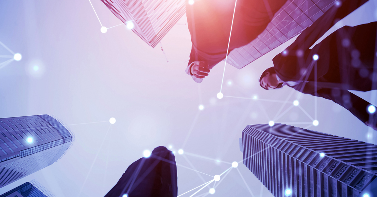 Low-angle view of businesspeople among tall skyscrapers with a digital network overlay