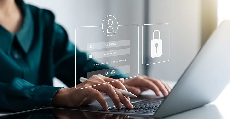 Hands typing on a laptop with a virtual login screen and padlock icon overlay