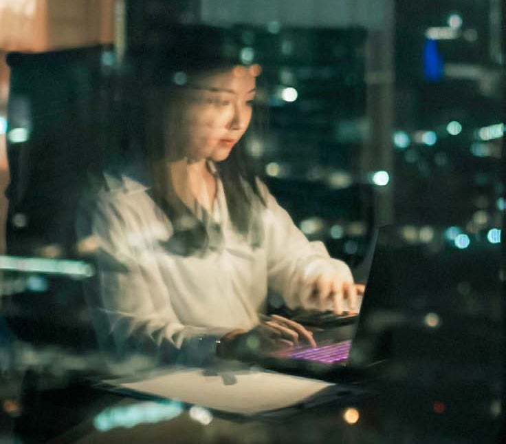 blurred image of woman on computer