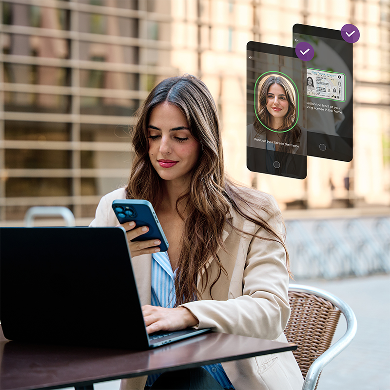 Person completing mobile identity verification while using a laptop