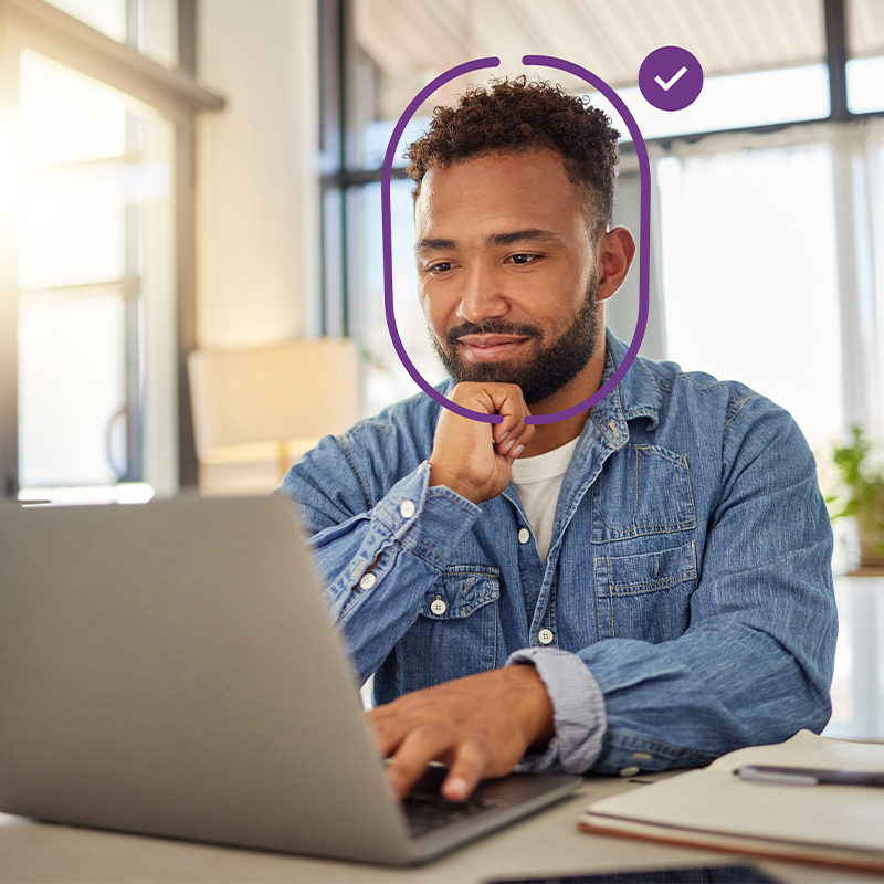 Person completing facial identity verification on a laptop