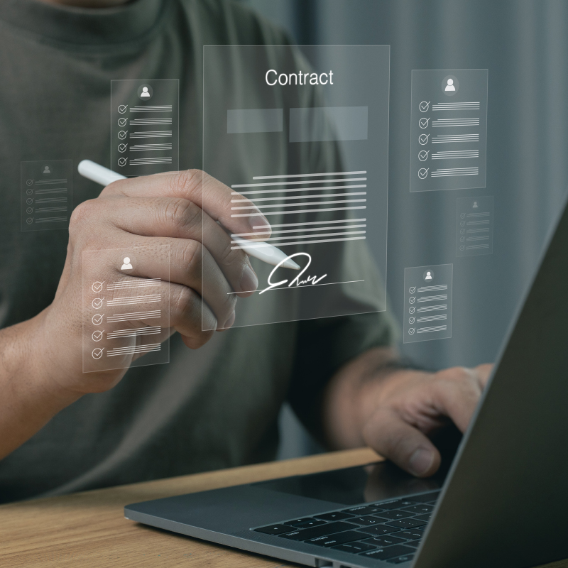 Person signing a digital contract on a laptop with electronic signature interface