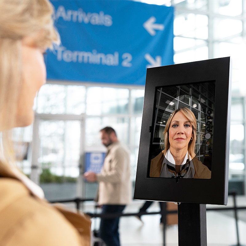 Traveler using facial recognition kiosk at airport terminal