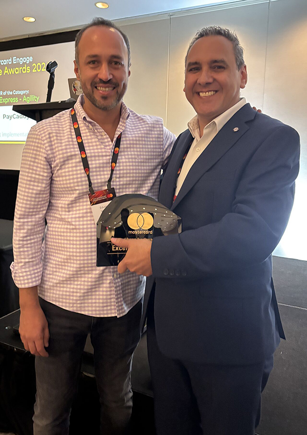 Two men holding a Mastercard award