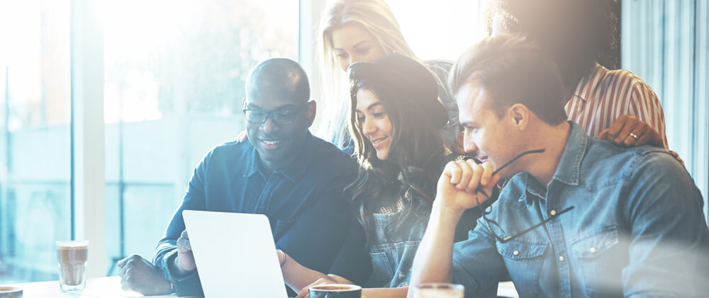 Group of people looking at a laptop