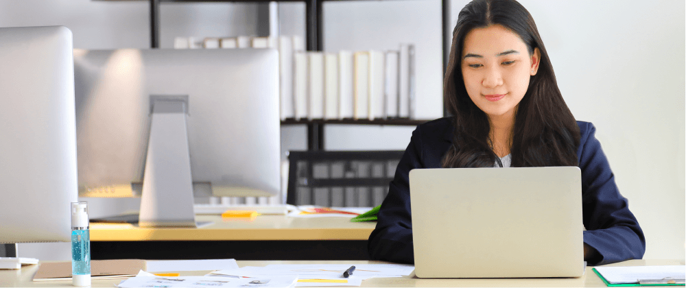 woman sitting at desk in front of laptop