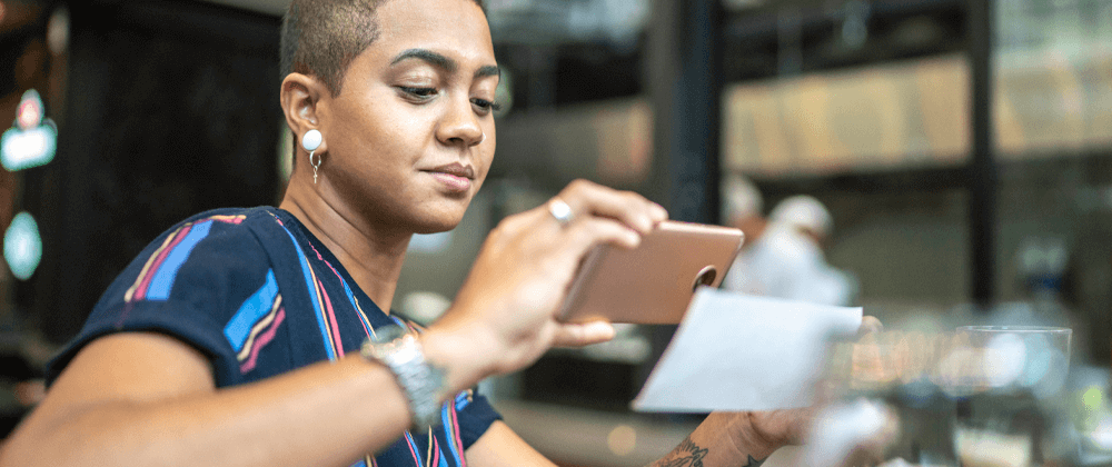 Woman scanning a check with a phone