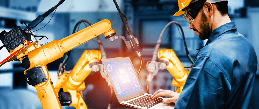 Man with a  hardhat using a laptop