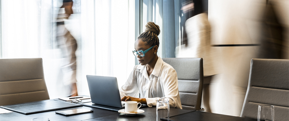 Woman sitting at a table and using a laptop