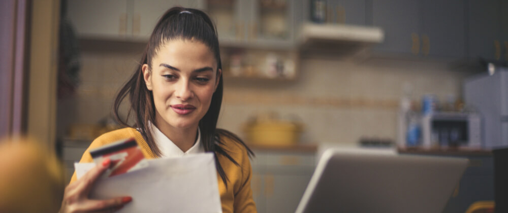 woman looking at credit card